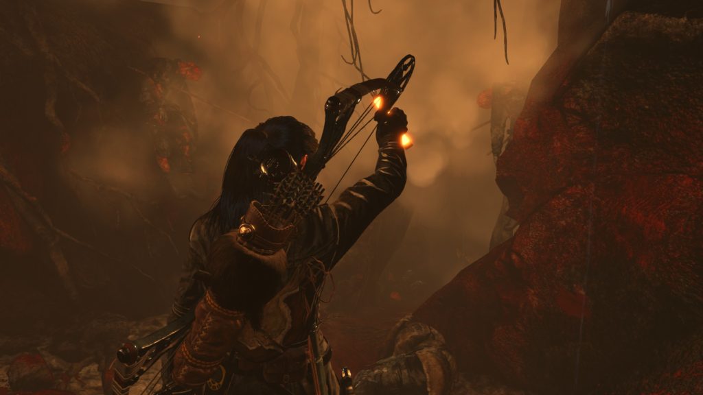 Rise of the Tomb Raider: lara walking through a gore splattered tunnel